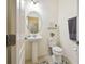 Charming powder room with pedestal sink, toilet, and decorative mirror at 2163 Plantation Oak Dr, Orlando, FL 32824