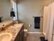 Bathroom featuring double sinks, granite countertop, tile flooring, and a shower with a curtain at 2987 Neverland Dr, New Smyrna Beach, FL 32168