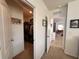 Hallway leading to walk-in closet with built-in shelving and hanging rods for ample storage space at 2987 Neverland Dr, New Smyrna Beach, FL 32168