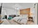 Bedroom features a wood accent wall and modern furniture at 5152 Belmont Park Way, Mulberry, FL 33860