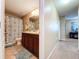 Neutral toned bathroom with vanity, toilet, shower, and decorative elements at 6455 Sedgeford Dr, Lakeland, FL 33811