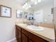 Bright bathroom with double sinks, a large mirror, vanity lighting, and neutral wall color at 6455 Sedgeford Dr, Lakeland, FL 33811