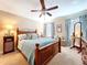 Charming bedroom with a wooden bed frame, soft lighting, and tasteful decorations at 6455 Sedgeford Dr, Lakeland, FL 33811