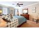 Cozy bedroom featuring a ceiling fan, a large dresser, and charming decor at 6455 Sedgeford Dr, Lakeland, FL 33811