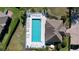 Overhead shot of community pool, featuring many chairs, landscaping, and pool house at 6455 Sedgeford Dr, Lakeland, FL 33811