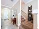 Bright foyer features tile flooring, a staircase, and an arched entryway at 6455 Sedgeford Dr, Lakeland, FL 33811