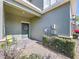 Charming front entrance with a decorative wreath, a bench and verdant landscaping at 6455 Sedgeford Dr, Lakeland, FL 33811