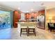 Kitchen island with seating, wood cabinets, stainless steel appliances, and a view to the patio at 6455 Sedgeford Dr, Lakeland, FL 33811