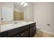 Bathroom with double sink vanity, a large mirror, and tiled floors at 9147 Shepton St, Orlando, FL 32825