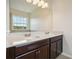 Bathroom features a double sink vanity with dark wood cabinetry at 9147 Shepton St, Orlando, FL 32825