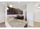 Well-lit kitchen showcasing granite countertops, dark cabinetry, and stainless steel appliances at 9147 Shepton St, Orlando, FL 32825