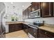 Bright kitchen featuring dark cabinetry, stainless steel appliances, and granite countertops at 9147 Shepton St, Orlando, FL 32825