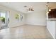 Bright living room featuring neutral tile floors, recessed lighting, and sliding glass doors to the outside at 9147 Shepton St, Orlando, FL 32825