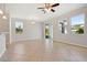 Bright living room featuring neutral tile floors, recessed lighting, and sliding glass doors to the outside at 9147 Shepton St, Orlando, FL 32825