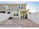 Back patio with brick pavers, featuring a white privacy fence and a sliding glass door at 9147 Shepton St, Orlando, FL 32825