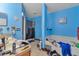 Bright blue bathroom featuring a vanity sink, soaking tub, and tiled floors at 114 Briarcliff Dr, Kissimmee, FL 34758