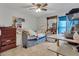 Cozy bedroom featuring tile floors, ceiling fan, and a gray bed with built-in storage drawers at 114 Briarcliff Dr, Kissimmee, FL 34758