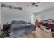 Bedroom with tile floors, ceiling fan, and a bed with nightstand and dresser at 114 Briarcliff Dr, Kissimmee, FL 34758