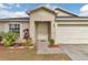 Inviting front entryway with decorative landscaping and a well-maintained exterior at 114 Briarcliff Dr, Kissimmee, FL 34758