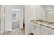 Bathroom with double granite vanity and a door leading to the bedroom at 2122 Rosewood Dr, Bartow, FL 33830