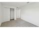 Bedroom featuring neutral carpet, white walls, closet with shelving and a hallway entrance at 2122 Rosewood Dr, Bartow, FL 33830