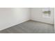 Clean bedroom showcasing neutral carpet, white walls, and natural light from a window at 2122 Rosewood Dr, Bartow, FL 33830