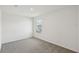 Bright bedroom featuring neutral carpet, white walls and a window providing natural light at 2122 Rosewood Dr, Bartow, FL 33830