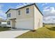 A modern two-story home displaying a spacious two-car garage and a neatly kept lawn at 2122 Rosewood Dr, Bartow, FL 33830