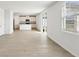 A light-filled living room blending into the kitchen featuring wood-look tile floors, neutral paint, and recessed lighting at 2122 Rosewood Dr, Bartow, FL 33830