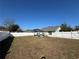 Expansive backyard featuring a white fence, a gazebo, and a neatly mowed lawn at 89 Winter Ridge Cir, Orlando, FL 32835