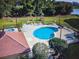 Aerial view of a community pool, playground, and a lakeside area, showing the recreational amenities at 6337 Parc Corniche Dr # 2101, Orlando, FL 32821