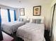 Comfortable bedroom with two beds, neutral bedding, and matching artwork, perfect for a relaxing retreat at 6337 Parc Corniche Dr # 2101, Orlando, FL 32821