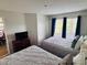 Bedroom featuring two beds, bright natural light through window, and an entertainment console at 6337 Parc Corniche Dr # 2101, Orlando, FL 32821
