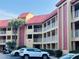 Condominium building with multiple levels, private balconies, parking and palm trees at 6337 Parc Corniche Dr # 2101, Orlando, FL 32821