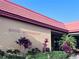 Hotel registration exterior featuring a red tile roof, landscaped greenery, and clear signage for easy guest access at 6337 Parc Corniche Dr # 2101, Orlando, FL 32821