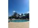 Outdoor pool area with multiple lounge chairs and a handicap pool access lift, under a bright sky at 6337 Parc Corniche Dr # 2101, Orlando, FL 32821