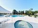Community swimming pool featuring lounge chairs, picnic tables, and shaded areas for relaxation and enjoyment at 6337 Parc Corniche Dr # 2101, Orlando, FL 32821