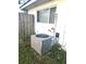 Exterior shot of the AC unit next to the house, showing its placement and condition at 663 Hager St, Deltona, FL 32725