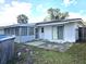View of backyard featuring a screened-in porch, concrete patio, and access to the home at 663 Hager St, Deltona, FL 32725