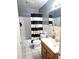 Bathroom with a bathtub, toilet, and vanity sink at 663 Hager St, Deltona, FL 32725