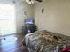 Bedroom with wood floors, a ceiling fan, and natural light from the window at 663 Hager St, Deltona, FL 32725