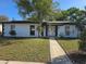 Charming single-story home featuring white walls, dark trim, and a well-maintained front lawn at 663 Hager St, Deltona, FL 32725