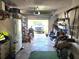 Cluttered garage interior with visible tools, appliances, and a vehicle parked outside at 663 Hager St, Deltona, FL 32725