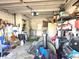 View of the garage, featuring a variety of stored items and home maintenance equipment at 663 Hager St, Deltona, FL 32725