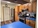 Functional kitchen featuring wood cabinets, stainless steel appliances, and blue countertops at 663 Hager St, Deltona, FL 32725