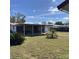 View of a large yard with established greenery, including a covered patio at 102 Center Sw St, Winter Haven, FL 33880