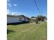Backyard with fenced perimeter and covered patio, as viewed from side yard at 102 Center Sw St, Winter Haven, FL 33880