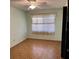 Cozy bedroom with ceiling fan, decorative window treatment, and hardwood floors at 102 Center Sw St, Winter Haven, FL 33880