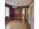 The dining room features laminate floors, a chandelier, and wallpaper at 102 Center Sw St, Winter Haven, FL 33880