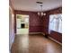 The dining room features laminate floors, a window, and wallpaper at 102 Center Sw St, Winter Haven, FL 33880
